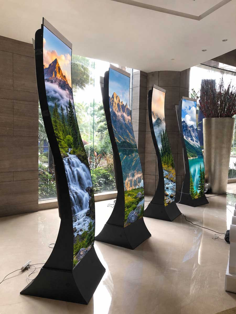 55-inch S-shaped flexible OLED displays showing scenic landscape content
